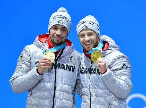 Gold medalist Germany s Tobias Wendl and Tobias Arlt celebrate during the medal ceremony for Luge Doubles at the Pyeongchang 2018 Winter Olympics in Pyeongchang, South Korea, on February 16, 2018.  OLY20180216367 KEVINxDIETSCH