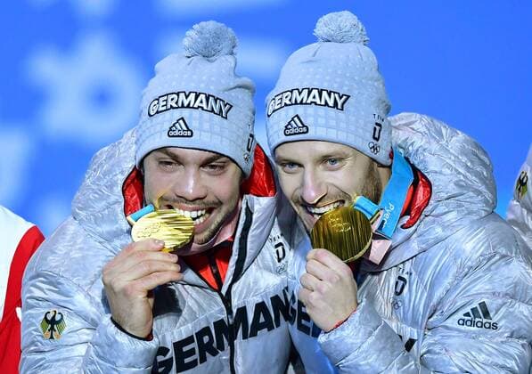 Gold medalist Germany s Tobias Wendl and Tobias Arlt celebrate during the medal ceremony for Luge Doubles at the Pyeongchang 2018 Winter Olympics in Pyeongchang, South Korea, on February 16, 2018.  OLY20180216363 KEVINxDIETSCH