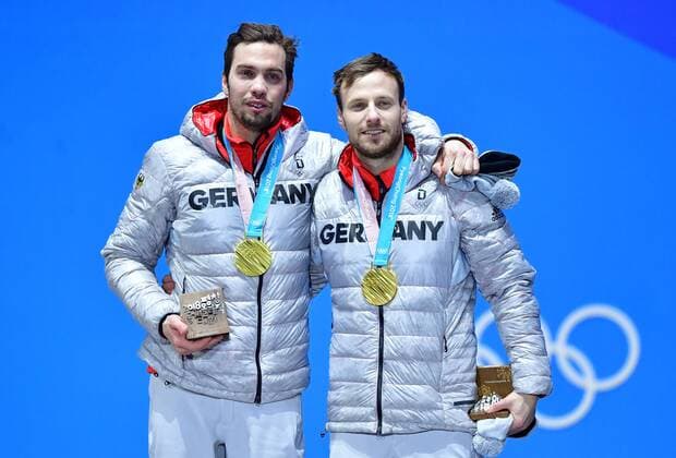 Gold medalist Germany s Tobias Wendl and Tobias Arlt celebrate during the medal ceremony for Luge Doubles at the Pyeongchang 2018 Winter Olympics in Pyeongchang, South Korea, on February 16, 2018.  OLY20180216365 KEVINxDIETSCH
