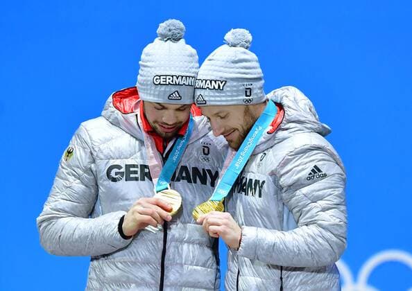 Gold medalist Germany s Tobias Wendl and Tobias Arlt celebrate during the medal ceremony for Luge Doubles at the Pyeongchang 2018 Winter Olympics in Pyeongchang, South Korea, on February 16, 2018.  OLY20180216368 KEVINxDIETSCH