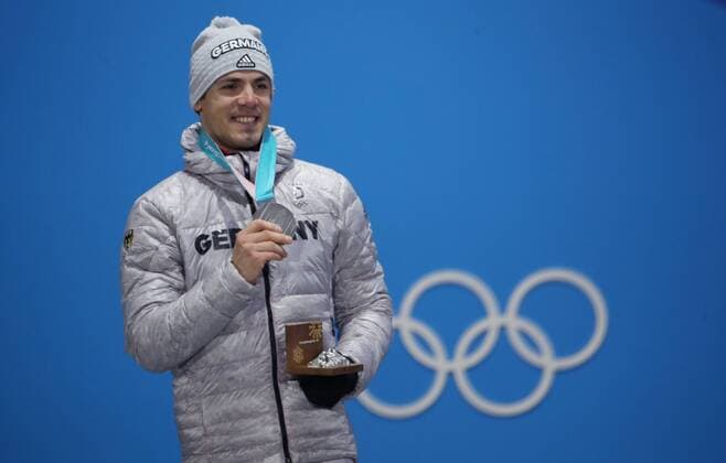 OLYMPICS - 2018 Winter Olympics PYEONGCHANG,SOUTH KOREA,19.FEB.18 - OLYMPICS, BIATHLON - Olympic Winter games Winterspiele Spiele Summer games PyeongChang 2018, Medals Plaza, 15km Mass Start, men, award ceremony. Image shows Simon Schempp (GER). Keywords: medal. GEPAxpictures xAndreasxPranter