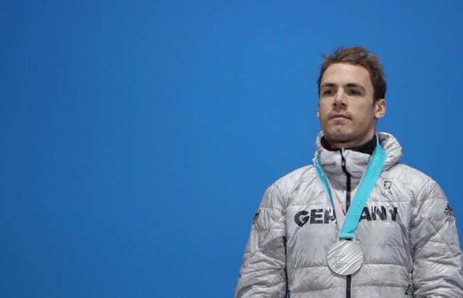 OLYMPICS - 2018 Winter Olympics PYEONGCHANG,SOUTH KOREA,19.FEB.18 - OLYMPICS, BIATHLON - Olympic Winter games Winterspiele Spiele Summer games PyeongChang 2018, Medals Plaza, 15km Mass Start, men, award ceremony. Image shows Simon Schempp (GER). Keywords: medal. GEPAxpictures xAndreasxPranter