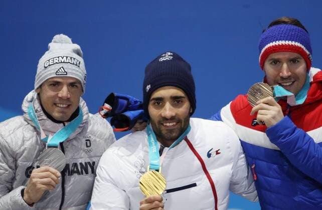 OLYMPICS - 2018 Winter Olympics PYEONGCHANG,SOUTH KOREA,19.FEB.18 - OLYMPICS, BIATHLON - Olympic Winter games Winterspiele Spiele Summer games PyeongChang 2018, Medals Plaza, 15km Mass Start, men, award ceremony. Image shows Simon Schempp (GER), Martin Fourcade (FRA) and Emil Hegle Svendsen (NOR). Keywords: medal. GEPAxpictures xAndreasxPranter
