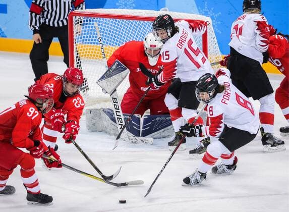 GANGNEUNG, SOUTH KOREA - FEBRUARY 19, 2018: Olympic Athlete from Russia, goaltender Valeria Tarakanova (C back) supported by Anna Shokhina and Maria Batalova (L-R front) defends against Canadaâ€™s Laura Fortino and Melodie Daoust (R-L front) in a women s semifinal Ice hockey Eishockey match as part of the 2018 Winter Olympic Games Olympische Spiele Olympia OS at the Gangneung Hockey Centre. Sergei Bobylev TASS  TS074AEF