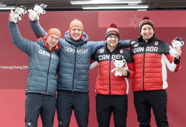 19 02 2018 Olympic sliding centre PyeongChang KOR PyeongChang 2018 sledding two-seater gentlemen Flower ceremony pictured Francesco Friedrich Thorsten Margis GER 1 place Justin Kripps Alexander Kopacz CAN 1 place gold medalist and Olympic champion Francesco Friedrich Thorsten Margis of Germany on Justin Kripps Alexander Kopacz of Canada during the mens doubles bobsleigh of the PyeongChang 2018 Winter Olympic Games at the Olympic sliding centre in PyeongChang of South Korea on 2018 02 19 PyeongChang  EX_GRO