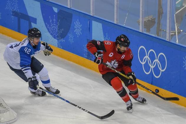PYEONGCHANG, South Korea - FEBRUARY 21: Canada men s hockey forward Andrew Ebbett (19) and Finland men s hockey defender Heiskanen Miro (42) chase a loose puck during the men s hockey semi final game between Canada and Finland during the 2018 Winter Olympic Games Olympische Spiele Olympia OS at the Gangneung Hockey Center on February 21, 2018 in PyeongChang, South Korea. Canada advances to the gold medal game with 1-0 victory. (Photo by Ken Murray Icon Sportswire) OLYMPICS: FEB 21 PyeongChang - Day 14 Icon18022114028 EDITORIAL USE ONLY