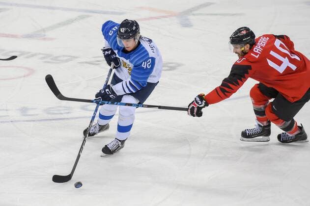 PYEONGCHANG, South Korea - FEBRUARY 21: Finland men s hockey defender Heiskanen Miro (42) looks to pass as Canada men s hockey forward Maxim Lapierre (40) defends during the men s hockey semi final game between Canada and Finland during the 2018 Winter Olympic Games Olympische Spiele Olympia OS at the Gangneung Hockey Center on February 21, 2018 in PyeongChang, South Korea. Canada advances to the gold medal game with 1-0 victory. (Photo by Ken Murray Icon Sportswire) OLYMPICS: FEB 21 PyeongChang - Day 14 Icon18022114035 EDITORIAL USE ONLY