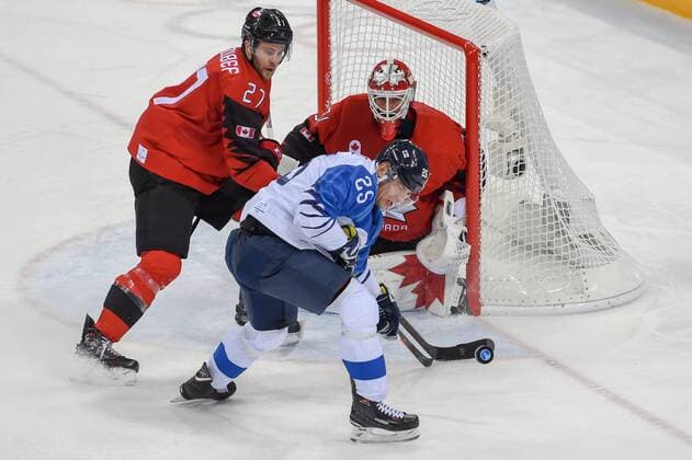 PYEONGCHANG, South Korea - FEBRUARY 21: Canada men s hockey defender Cody Goloubef (27) and Finland men s hockey forward Enlund Jonas (25) each fight to get their stick on the puck as Canada men s hockey goalie Kevin Poulin (31) watches during the men s hockey semi final game between Canada and Finland during the 2018 Winter Olympic Games Olympische Spiele Olympia OS at the Gangneung Hockey Center on February 21, 2018 in PyeongChang, South Korea. Canada advances to the gold medal game with 1-0 victory. (Photo by Ken Murray Icon Sportswire) OLYMPICS: FEB 21 PyeongChang - Day 14 Icon18022114039 EDITORIAL USE ONLY