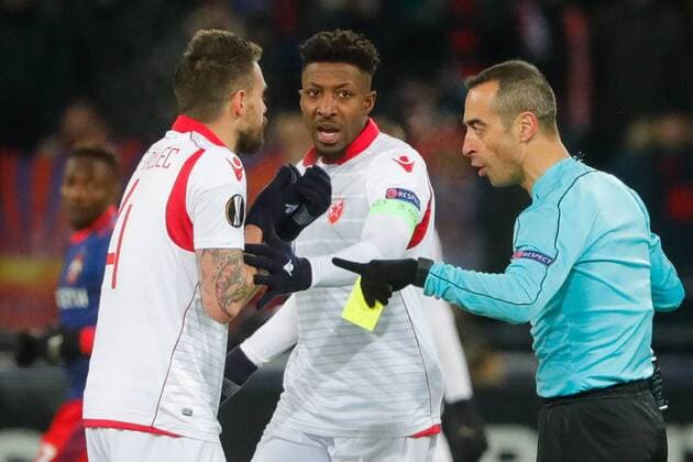 MOSCOW, RUSSIA - FEBRUARY 21, 2018: Crvena Zvezda Belgradeâ€™s Damien Le Tallec, Mitchell Donald, and referee Jorge Sousa (L-R) in their 2017-2018 UEFA Europa League Round of 32 second leg football match against CSKA Moscow at VEB Arena in Moscow. Mikhail Metzel TASS  TS07522D