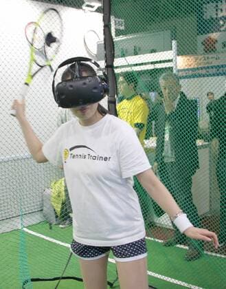 VR tennis A woman experiences the virtual reality tennis game introduced by Libzent Innovations Inc. at an exhibition in Chiba, Japan, on Feb. 21, 2018. 