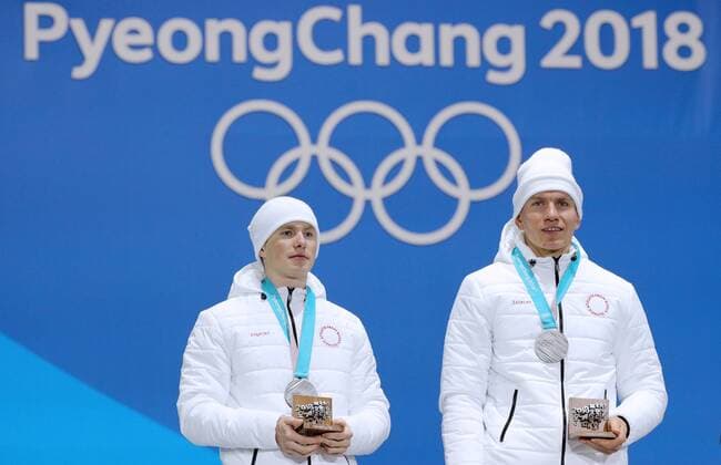 PYEONGCHANG, SOUTH KOREA - FEBRUARY 22, 2018: Silver medalists, Olympic Athletes from Russia Denis Spitsov (L) and Alexander Bolshunov during a victory ceremony for the men s cross-country skiing team sprint free event at the 2018 Winter Olympic Games Olympische Spiele Olympia OS at Medal Plaza. Sergei Bobylev TASS  TS07537E