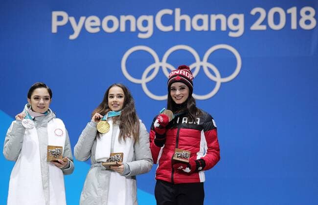 PYEONGCHANG, SOUTH KOREA â€“ FEBRUARY 23, 2018: Silver medallist Evgenia Medvedeva, Olympic Athlete from Russia, gold medallist Alina Zagitova, Olympic Athlete from Russia, and bronze medallist Kaetlyn Osmond of Canada, from left, pose at a victory ceremony for the ladies Figure skating Eiskunstlauf event at the 2018 Winter Olympic Games Olympische Spiele Olympia OS Sergei Bobylev TASS  TS0756EE
