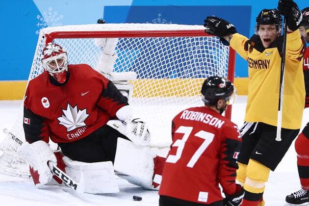 GANGNEUNG, SOUTH KOREA â€“ FEBRUARY 23, 2018: Germany s David Wolf (R) celebrates as Canada s goaltender Kevin Poulin (L) concedes a goal in their men s semifinal Ice hockey Eishockey match during the 2018 Winter Olympic Games Olympische Spiele Olympia OS at the Gangneung Hockey Centre. Valery Sharifulin TASS  TS075761