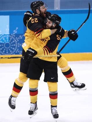 GANGNEUNG, SOUTH KOREA â€“ FEBRUARY 23, 2018: Germany s Matthias Plachta (L) and Feliz Schutz celebrate scoring in their men s semifinal Ice hockey Eishockey match against Canada during the 2018 Winter Olympic Games Olympische Spiele Olympia OS at the Gangneung Hockey Centre. Valery Sharifulin TASS  TS07578A