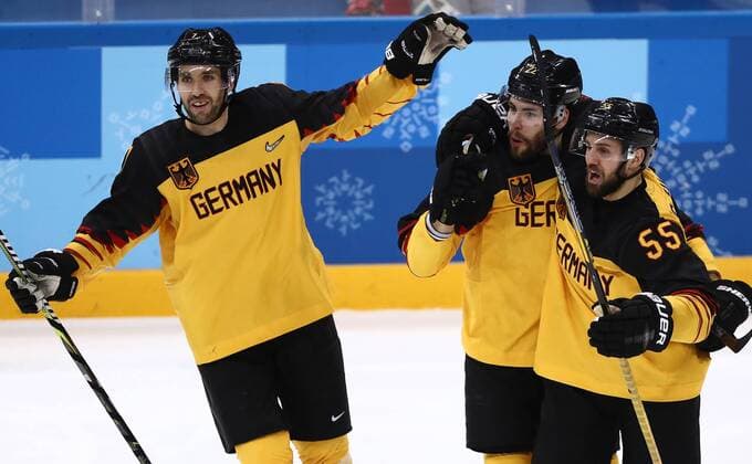 GANGNEUNG, SOUTH KOREA â€“ FEBRUARY 23, 2018: Germany s Daryl Boyle, Matthias Plachta, and Feliz Schutz (L-R) celebrate scoring in their men s semifinal Ice hockey Eishockey match against Canada during the 2018 Winter Olympic Games Olympische Spiele Olympia OS at the Gangneung Hockey Centre. Valery Sharifulin TASS  TS07578D
