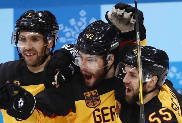 GANGNEUNG, SOUTH KOREA â€“ FEBRUARY 23, 2018: Germany s Daryl Boyle, Matthias Plachta, and Feliz Schutz (L-R) celebrate scoring in their men s semifinal Ice hockey Eishockey match against Canada during the 2018 Winter Olympic Games Olympische Spiele Olympia OS at the Gangneung Hockey Centre. Valery Sharifulin TASS  TS07578E