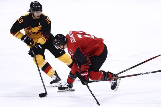 GANGNEUNG, SOUTH KOREA â€“ FEBRUARY 23, 2018: Germany s Christian Ehrhoff (L) and Canada s Mason Raymond in action in their men s semifinal Ice hockey Eishockey match during the 2018 Winter Olympic Games Olympische Spiele Olympia OS at the Gangneung Hockey Centre. Valery Sharifulin TASS  TS07579A