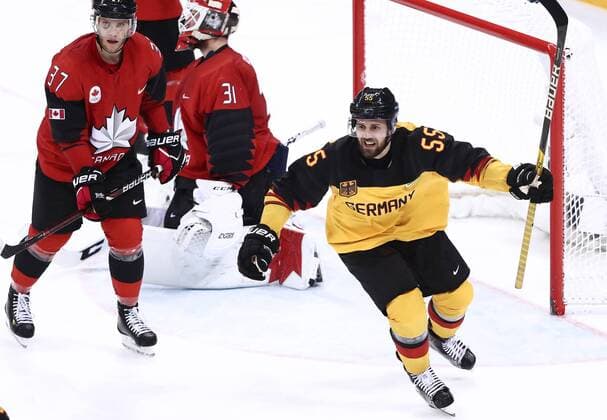 GANGNEUNG, SOUTH KOREA â€“ FEBRUARY 23, 2018: Germany s Felix Schutz (R) reacts as Canada s goaltender Kevin Poulin concedes a goal in their men s semifinal Ice hockey Eishockey match during the 2018 Winter Olympic Games Olympische Spiele Olympia OS at the Gangneung Hockey Centre. Valery Sharifulin TASS  TS07579B