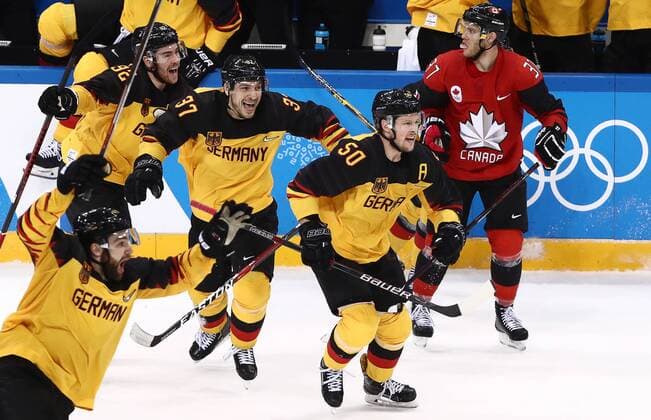 GANGNEUNG, SOUTH KOREA â€“ FEBRUARY 23, 2018: Germany s Marcel Noebels, Patrick Reimer, and Patrick Hager (L-R) celebrate winning their men s semifinal Ice hockey Eishockey match against Canada during the 2018 Winter Olympic Games Olympische Spiele Olympia OS at the Gangneung Hockey Centre. Team Germany won the game 4-3 and propelled to the final. Valery Sharifulin TASS  TS0757C3