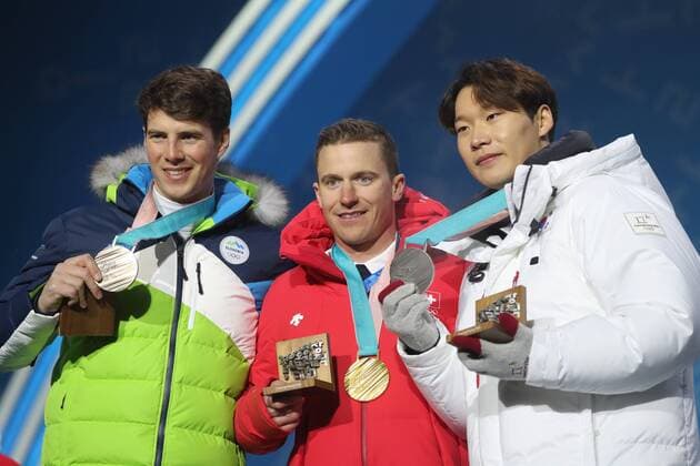 OLYMPICS - 2018 Winter Olympics PYEONGCHANG,SOUTH KOREA,24.FEB.18 - OLYMPICS, SNOWBOARDING - Olympic Winter games Winterspiele Spiele Summer games PyeongChang 2018, Medals Plaza, award ceremony, parallel giant slalom, men. Image shows Zan Kosir (SLO), Nevin Galmarini (SUI) and Sangho Lee (KOR). Keywords: medal. GEPAxpictures xMathiasxMandl