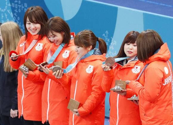 Pyeongchang Olympics Members of the Japanese women s curling team look at their bronze medals during the medal ceremony at the Pyeongchang Winter Olympics in Gangneung, South Korea on Feb. 25, 2018. 