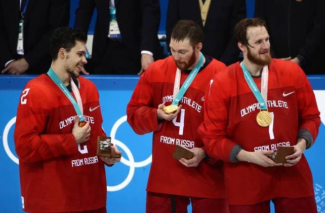 GANGNEUNG, SOUTH KOREA - FEBRUARY 25, 2018: Gold medalists, the Olympic Athletes from Russia, Artyom Zub, Vladislav Garvikov, and Ivan Telegin (L-R) at a victory ceremony for the men s Ice hockey Eishockey event at Gangneung Hockey Centre at the 2018 Winter Olympic Games Olympische Spiele Olympia OS The Olympic Athletes from Russia won 4-3 in overtime. Valery Sharifulin TASS  TS075A5A