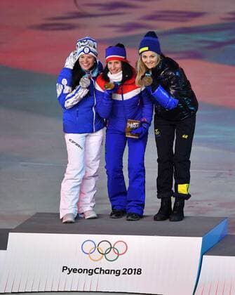 Silver medalist Krista Parmakoski of Finland, gold medalist Marit Bjorgen of Norway and bronze medalist Stina Nilsson of Sweden stand together at the medal ceremony for the Cross-Country Skiing Ladies 30km Mass Start Classic at the closing ceremony for the Pyeongchange 2018 Winter Olympics at the Olympic Stadium in Daegwalnyeong, South Korea, on February 25, 2018.  KOL20180225855 RICHARDxELLIS