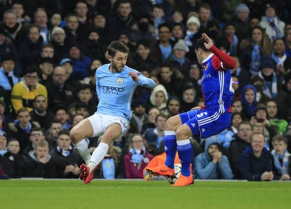 7th March 2018, Etihad Stadium, Manchester, England; UEFA Champions League football, round of 16, 2nd leg, Manchester City versus FC Basel; Bernardo Silva of Manchester City and Blas Riveros of Basel challenge for the ball  ActionPlus11998985