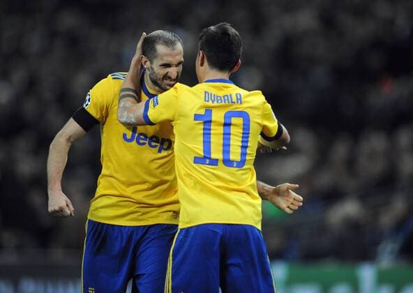 Football - 2017 2018 UEFA Champions League - Round of Sixteen, Second Leg: Tottenham Hotspur (2) vs. Juventus (2) Paulo Dybala of Juventus celebrates scoring goal no 2, with Georgio Chiellini at Wembley Stadium. COLORSPORT ANDREW COWIE 
