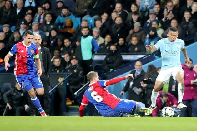 Gabriel Jesus of Manchester City (R) is challenged by Fabian Frei (C) of FC Basel 1893 during the UEFA Champions League match at the Etihad Stadium, Manchester , Britain on 07 March 2018, between Manchester City and FC Basel. Manchester City v FC Basel UCL_2017_18