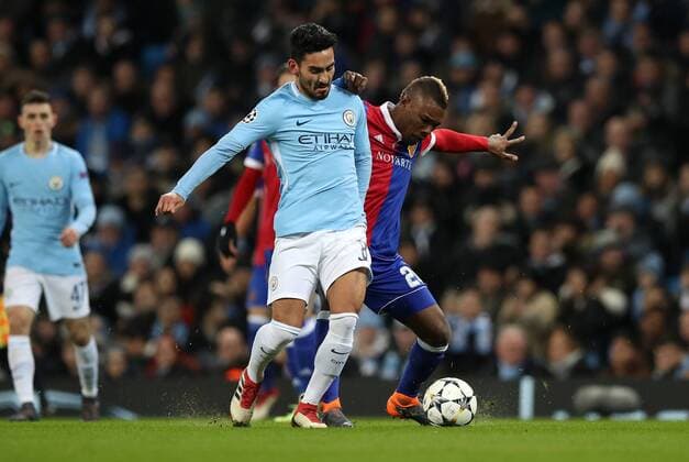 Football - 2017 2018 UEFA Champions League - Round of Sixteen, Second Leg: Manchester City (4) vs. FC Basel (0) Geoffrey Serey Die of FC Basel and Ilkay Gundogan of Manchester City at The Etihad. COLORSPORT 