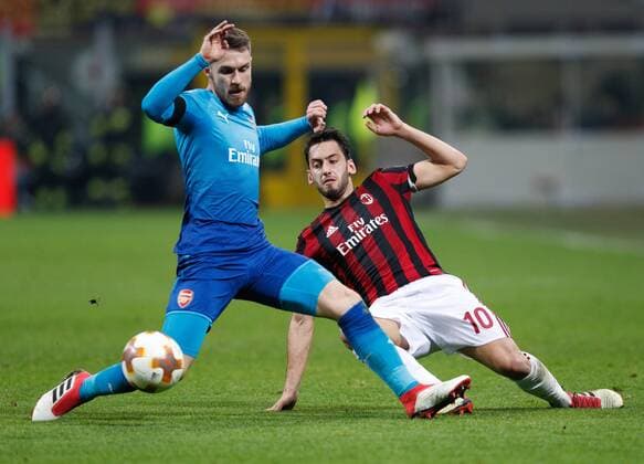 Hakan Calhanoglu of Ac Milan against Aaron Ramsey of Arsenal during the UEFA Europa League Round of 16 match between AC Milan and Arsenal at Stadio San Siro, Milan, Italy on 8 March 2018. Copyright: xRobertoxBreganix 19210016