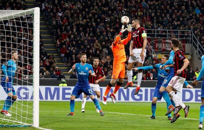 David Ospina of Arsenal against Leonardo Bonucci of Ac Milan during the UEFA Europa League Round of 16 match between AC Milan and Arsenal at Stadio San Siro, Milan, Italy on 8 March 2018. Copyright: xRobertoxBreganix 19210021