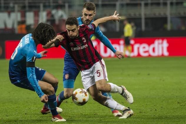 8th March 2018, San Siro, Milan, Italy; UEFA Europa League football, round of 16, 1st leg, AC Milan versus Arsenal FC; Giacomo Bonaventura of AC Milan competes for the ball with Mohamed Elneny (ars)  ActionPlus11999368