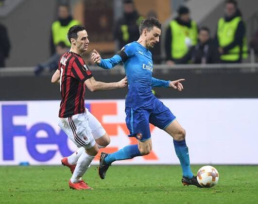 (180309) -- MILAN, March 9, 2018 -- AC Milan s Nikola Kalinic (L) competes with Arsenal s Laurent Koscielny during a Europa League round of 16 first leg soccer match between AC Milan and Arsenal at the San Siro stadium in Milan, Italy, March 8, 2018. Arsenal won 2-0. ) (SP)ITALY-MILAN-EUROPA LEAGUE-AC MILAN VS ARSENAL AlbertoxLingria 