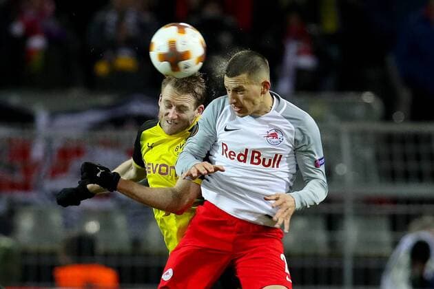 (180309) -- DORTMUND, March 9, 2018 -- Andre Schurrle (L) of Dortmund vies with Stefan Lainer of Salzburg during the UEFA Europa League round of 16 first leg match between Germany s Borussia Dortmund and Austria s FC Red Bull Salzburg at the Signal Iduna Park in Dortmund, Germany, on March 8, 2018. FC Red Bull Salzburg won 2-1. ) (SP)GERMANY-DORTMUND-EUROPA LEAGUE-BVB VS SALZBURG JoachimxBywaletz 