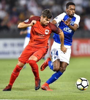(180313) -- DOHA, March 13, 2018 -- Mokhtar Falatah (R) of Al-Hilal FC vies with Gonzalo Viera of Al-Rayyan during the AFC Champions League Group D soccer match between Qatar s Al-Rayyan and Saudi Arabia s Al-Hilal FC at Jassim Bin Hamad Stadium in Doha, capital of Qatar, March 12, 2018. Qatar s Al-Rayyan won 2-1. ) (SP)QATAR-DOHA-SOCCER-AFC CHAMPIONS-GROUP D Nikku 