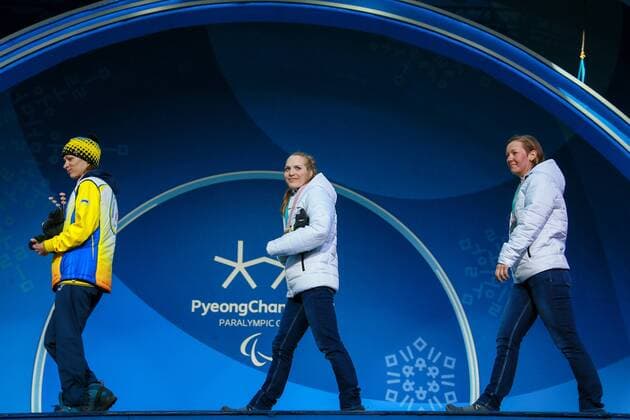 PYEONGCHANG, SOUTH KOREA - MARCH 13, 2018: Third-placed Liudmyla Liashenko of Ukraine, first- and second-placed neutral Paralympic athletes (NPA) from Russia Yekaterina Rumyantseva and Anna Milenina (L-R) attend a ceremony to award the women s 10km standing biathlon race winners at the 2018 Winter Paralympic Games. Vladimir Smirnov TASS  TS077712