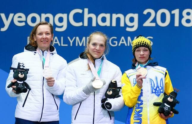 PYEONGCHANG, SOUTH KOREA - MARCH 13, 2018: Second- and first-placed neutral Paralympic athletes (NPA) from Russia Anna Milenina, Yekaterina Rumyantseva, and third-placed Liudmyla Liashenko (L-R) of Ukraine pose at a ceremony to award the women s 10km standing biathlon race winners at the 2018 Winter Paralympic Games. Vladimir Smirnov TASS  TS077737