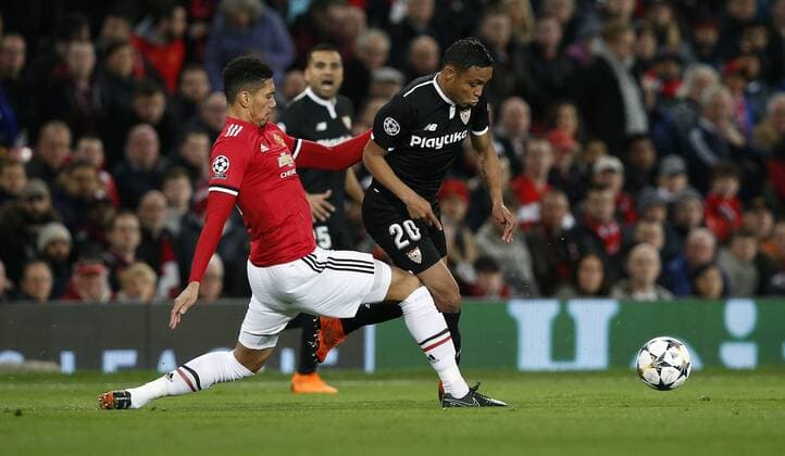 Chris Smalling of Manchester United ManU and Luis Muriel of Sevilla during the Champions League Round of 16 match at Old Trafford Stadium, Manchester. Picture date: March 13th 2018. Picture credit should read: Andrew Yates Sportimage EDITORIAL USE ONLY. No use with unauthorised audio, video, data, fixture lists, club league logos or live services. Online in-match use limited to 120 images, no video emulation. No use in betting, games or single club league player publications.