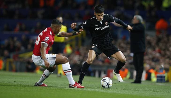 Joaquin Correa of Sevilla and Antonio Valencia of Manchester United ManU during the Champions League Round of 16 match at Old Trafford Stadium, Manchester. Picture date: March 13th 2018. Picture credit should read: Andrew Yates Sportimage EDITORIAL USE ONLY. No use with unauthorised audio, video, data, fixture lists, club league logos or live services. Online in-match use limited to 120 images, no video emulation. No use in betting, games or single club league player publications.