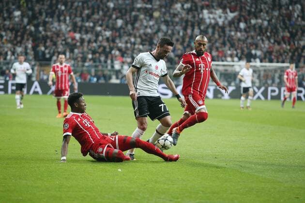 Gokhan Gonul (C) of Besiktas and Arturo Vidal (R) , David Alaba of Bayern Munchen during the Champions league second leg match between Besiktas and Bayern Munchen at Vodafone Park in Istanbul , Turkey on March 14 , 2018. 