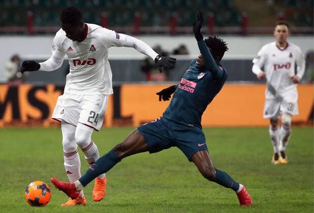 MOSCOW, RUSSIA - MARCH 15, 2018: Lokomotiv Moscow s Eder (L) and Atletico Madrid s Thomas Teye Partey fight for the ball in their 2017-2018 UEFA Europa League Round of 16 second leg football match at RZD Arena (Lokomotiv Stadium). Valery Sharifulin TASS  TS077E18