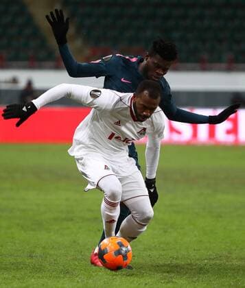MOSCOW, RUSSIA - MARCH 15, 2018: Lokomotiv Moscow s Eder (L) and Atletico Madrid s Thomas Teye Partey fight for the ball in their 2017-2018 UEFA Europa League Round of 16 second leg football match at RZD Arena (Lokomotiv Stadium). Valery Sharifulin TASS  TS077E19
