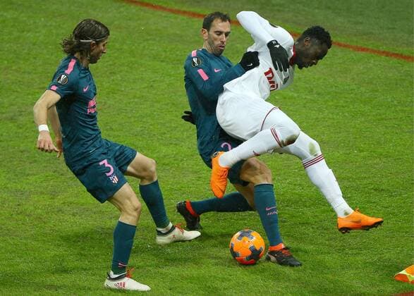 MOSCOW, RUSSIA - MARCH 15, 2018: Atletico Madrid s Felipe Luis, Diego Godin and Lokomotiv Moscow s Jefferson Farfan (L-R) fight for the ball in their 2017-2018 UEFA Europa League Round of 16 second leg football match at RZD Arena (Lokomotiv Stadium). Atletico Madrid won the game 5-1. Mikhail Tereshchenko TASS  TS077E28