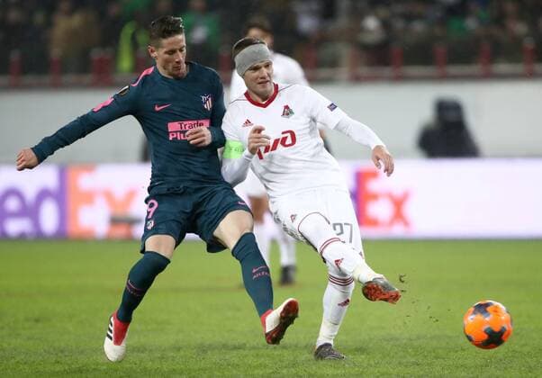 MOSCOW, RUSSIA - MARCH 15, 2018: Atletico Madrid s Fernando Torres (L) and Lokomotiv Moscow s Igor Denisov fight for the ball in their 2017-2018 UEFA Europa League Round of 16 second leg football match at RZD Arena (Lokomotiv Stadium). Atletico Madrid won the game 5-1. Valery Sharifulin TASS  TS077E33