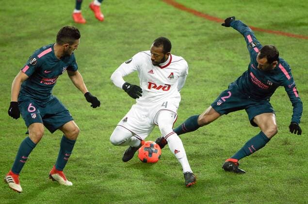 MOSCOW, RUSSIA - MARCH 15, 2018: Atletico Madrid s Koke, Lokomotiv Moscow s Manuel Fernandes and Atletico Madrid s Diego Godin (L-R) in action in their 2017-2018 UEFA Europa League Round of 16 second leg football match at RZD Arena (Lokomotiv Stadium). Atletico Madrid won the game 5-1. Mikhail Tereshchenko TASS  TS077E47