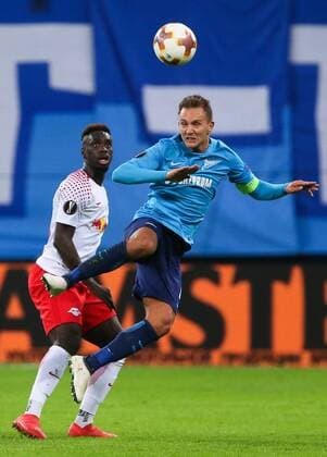 ST PETERSBURG, RUSSIA - MARCH 15, 2018: RB Leipzig s Jean-Kevin Augustin (L) and Zenit St Petersburg s Domenico Criscito fight for the ball in their 2017-2018 UEFA Europa League Round of 16 second leg football match at Saint Petersburg Stadium. Peter Kovalev TASS  TS077E67