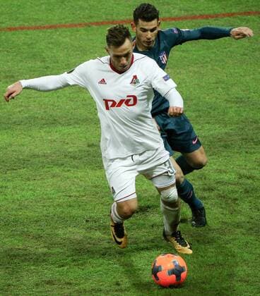 MOSCOW, RUSSIA - MARCH 15, 2018: Lokomotiv Moscow s Maciej Rybus (L) and Atletico Madrid s Lucas Hernandez fight for the ball in their 2017-2018 UEFA Europa League Round of 16 second leg football match at RZD Arena (Lokomotiv Stadium). Atletico Madrid won the game 5-1. Mikhail Tereshchenko TASS  TS077E5D