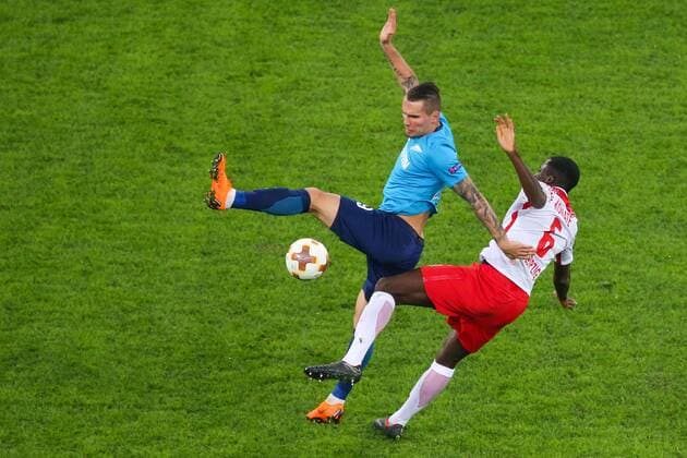 ST PETERSBURG, RUSSIA - MARCH 15, 2018: Zenit St Petersburg s Anton Zabolotny (L) and RB Leipzig s Ibrahima Konate fight for the ball in their 2017-2018 UEFA Europa League Round of 16 second leg football match at Saint Petersburg Stadium. Peter Kovalev TASS  TS077E6D